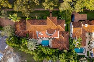 An aerial shot of a luxury home in Miami featuring a pool and lush greenery.